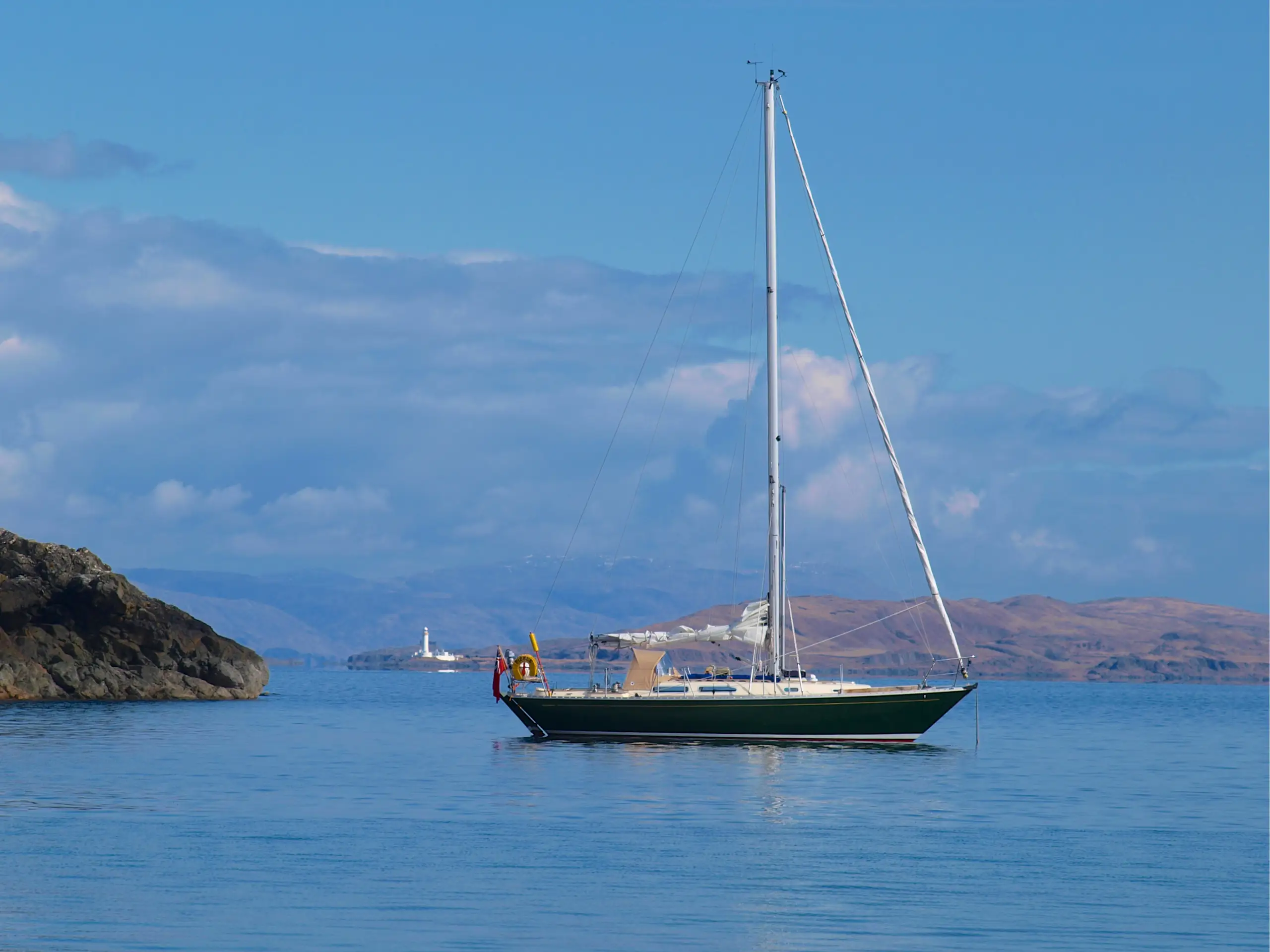 Pickle at anchor with the Lismore Lighthouse in the distance