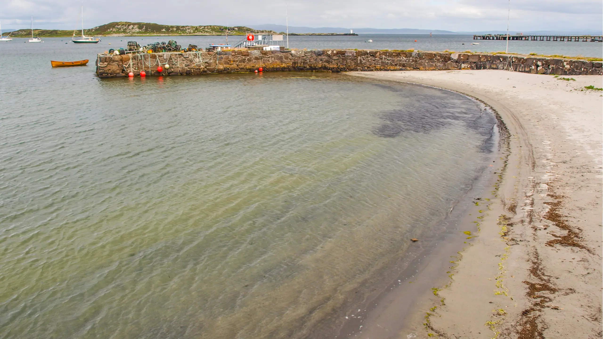 The harbour wall enclosing the small beach