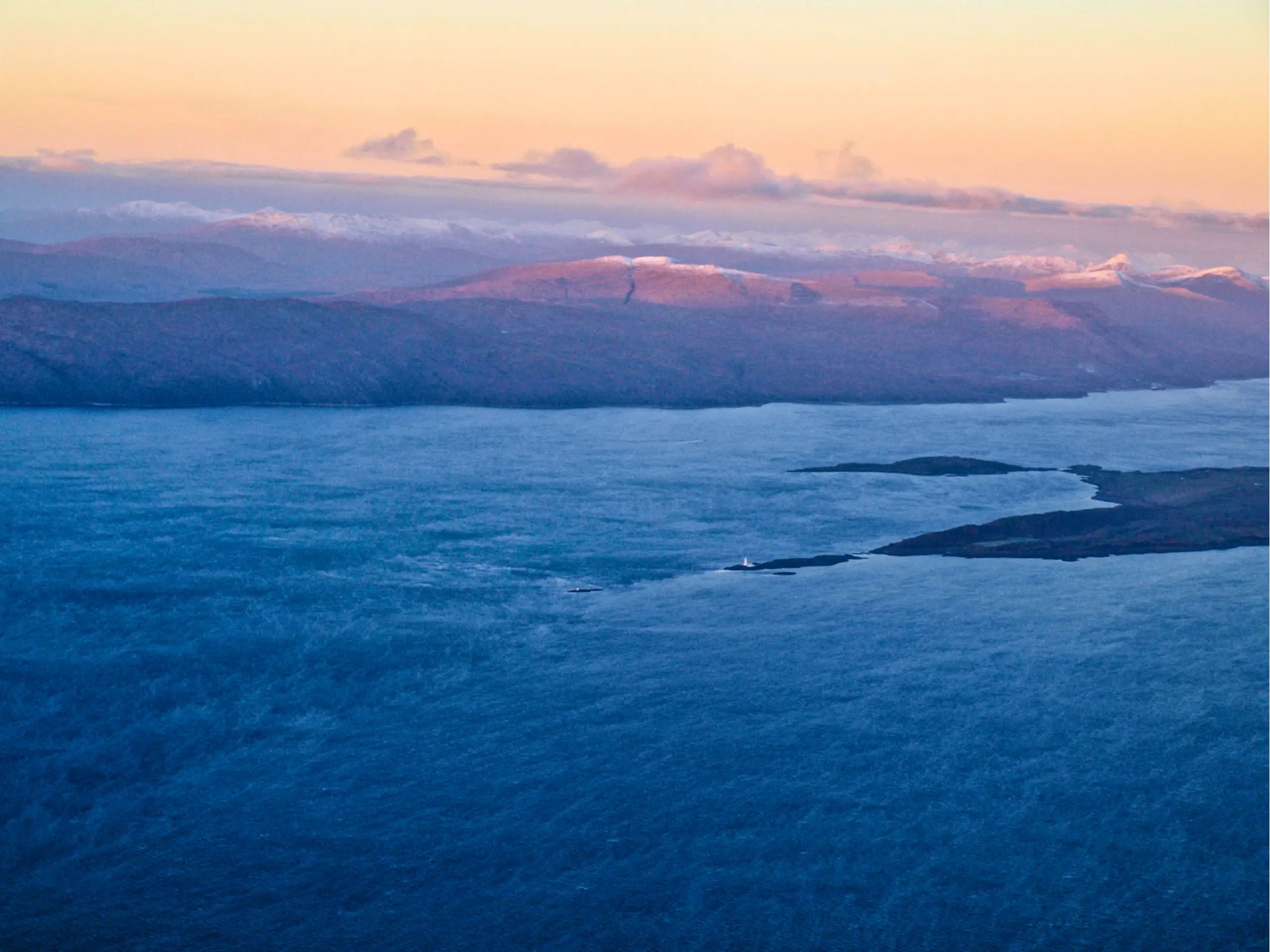 The lighthouse looks very small from the air