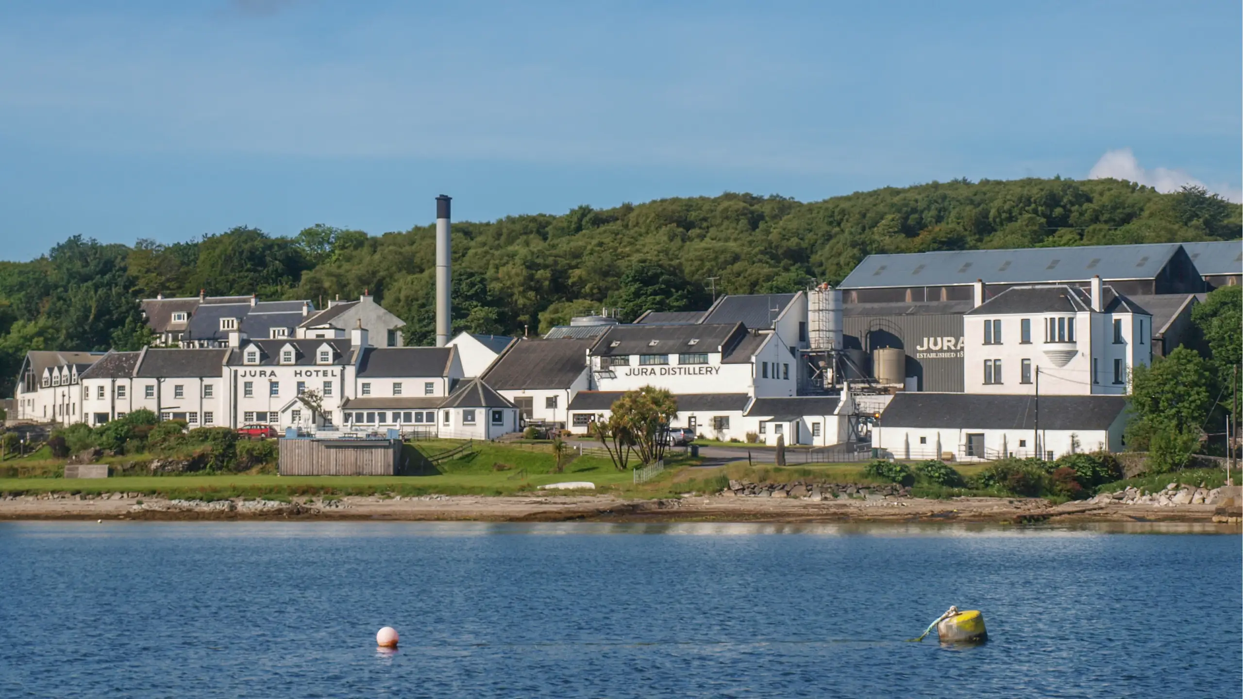 The tempting ensemble seen from a mooring — the hotel and distillery