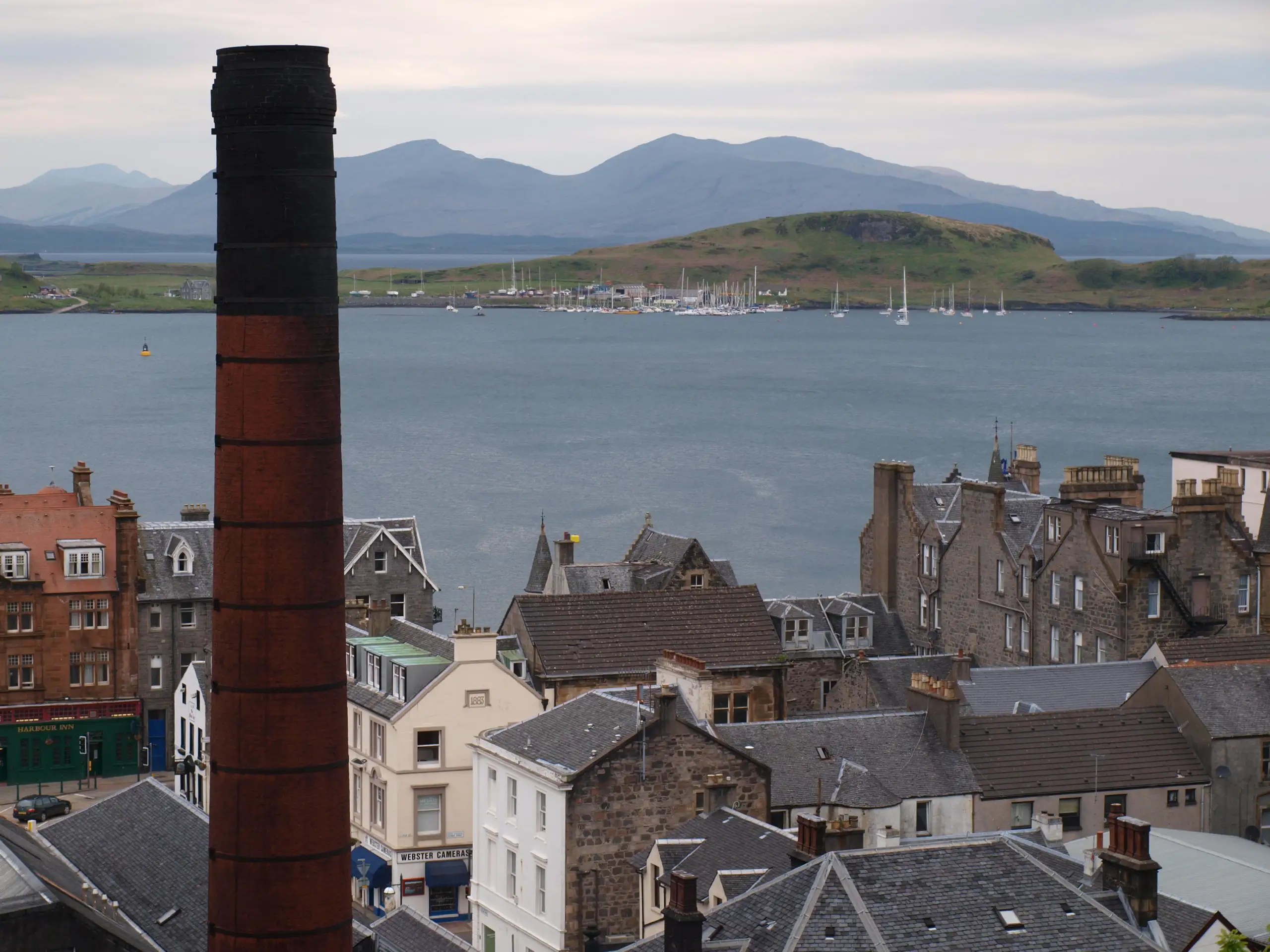 Looking down on Oban Bay with the distillery chimney in the foreground, Mull beyond